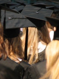 Photo of graduates wearing mortar boards and gowns